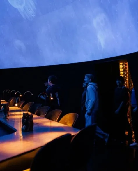 The dome lit in deep blue tones during a later course